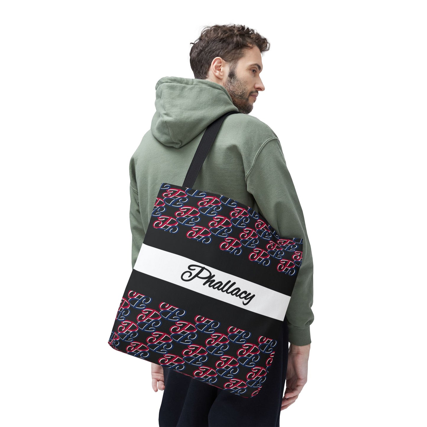 Man wearing green hoodie carrying a black designer tote bag with red and blue pattern by Phallacy