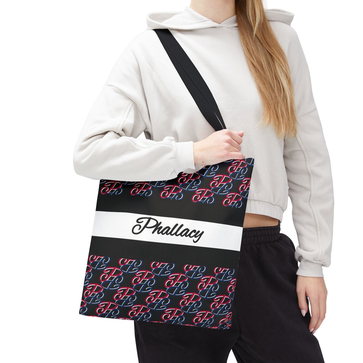 Phallacy designer tote bag with black red blue pattern and Phallacy text worn by person in white hoodie