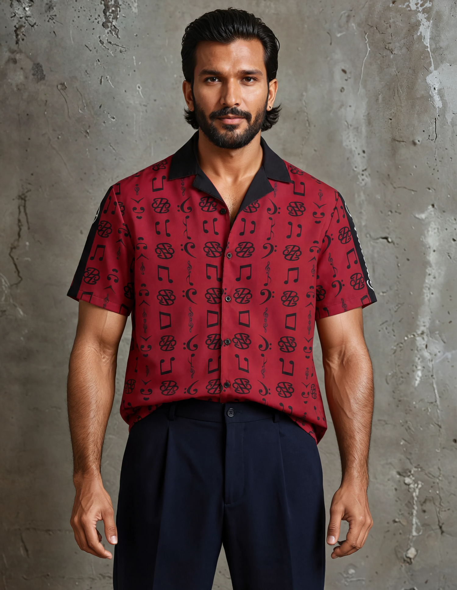 Man wearing a black and white striped designer polo shirt showcasing designer men's fashion online